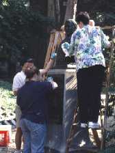 Seminar participants cleaning Tompkins sculpture